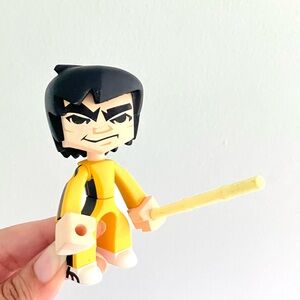 Kidrobot Bruce Lee with fighting stick vinyl figure